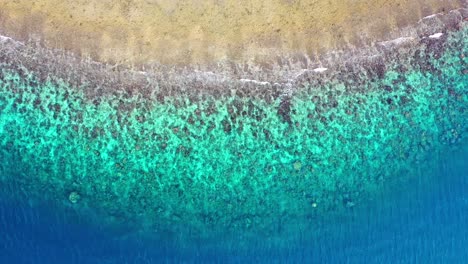 top down shot of blue and green transparent water at the beach in the mediterranean