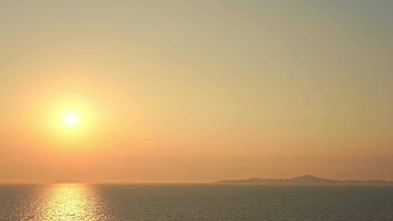 Sunset over the sea in Europe. Sun goes down over the water horizon in the evening