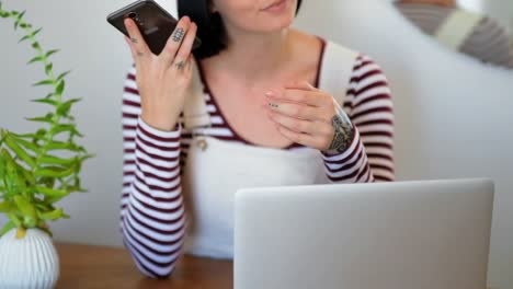 Woman-using-mobile-phone-at-home-4k