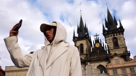 female tourist make video call near church of our lady before tyn, prague