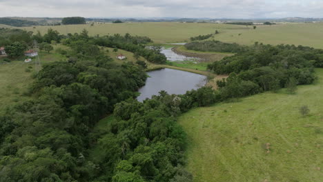 aerial footage flying over a pond in the countryside in brazil