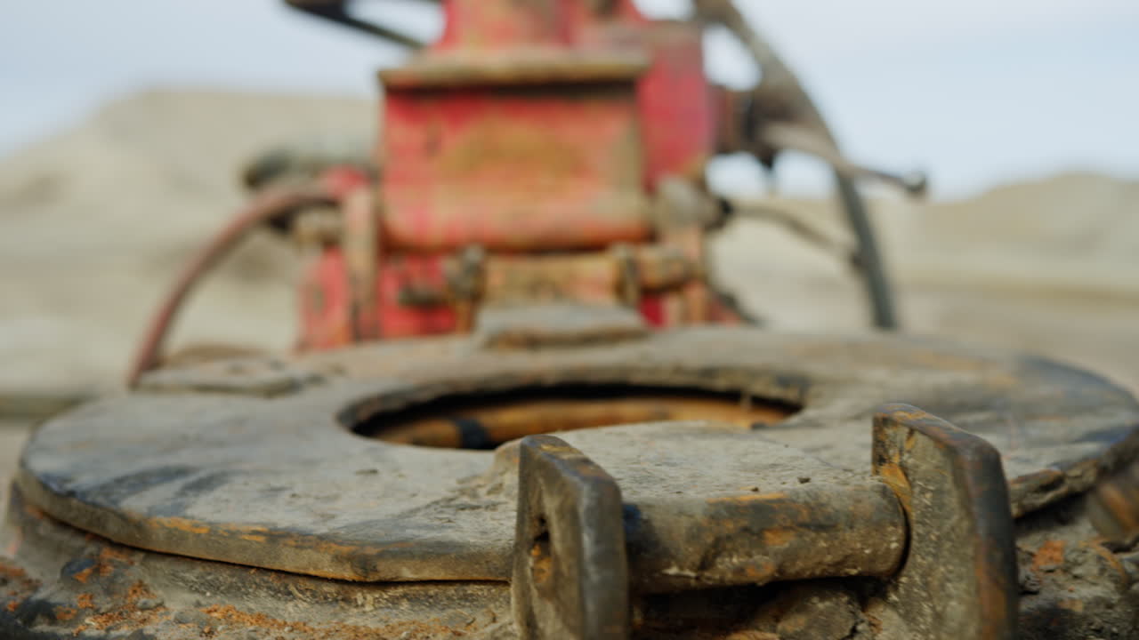 Hands in protective gloves arrange the metal details of the drilling equipment. Oil or gas production concept.