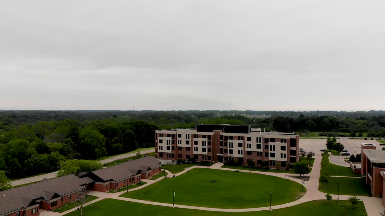 Aerial drone view of university grounds with school buildings, residence halls and central grass yard in the middle of University of Wisconsin - Parkside.