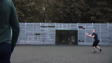 men playing football on an outdoor court