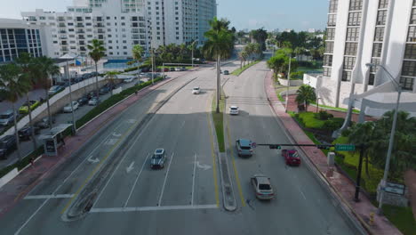 Vista-De-ángulo-Alto-Del-Tráfico-En-La-Carretera-En-La-Ciudad.-Seguimiento-De-Coches-En-Autopista-De-Varios-Carriles.-Palmeras-Y-Vegetación-Tropical.-Miami,-Estados-Unidos