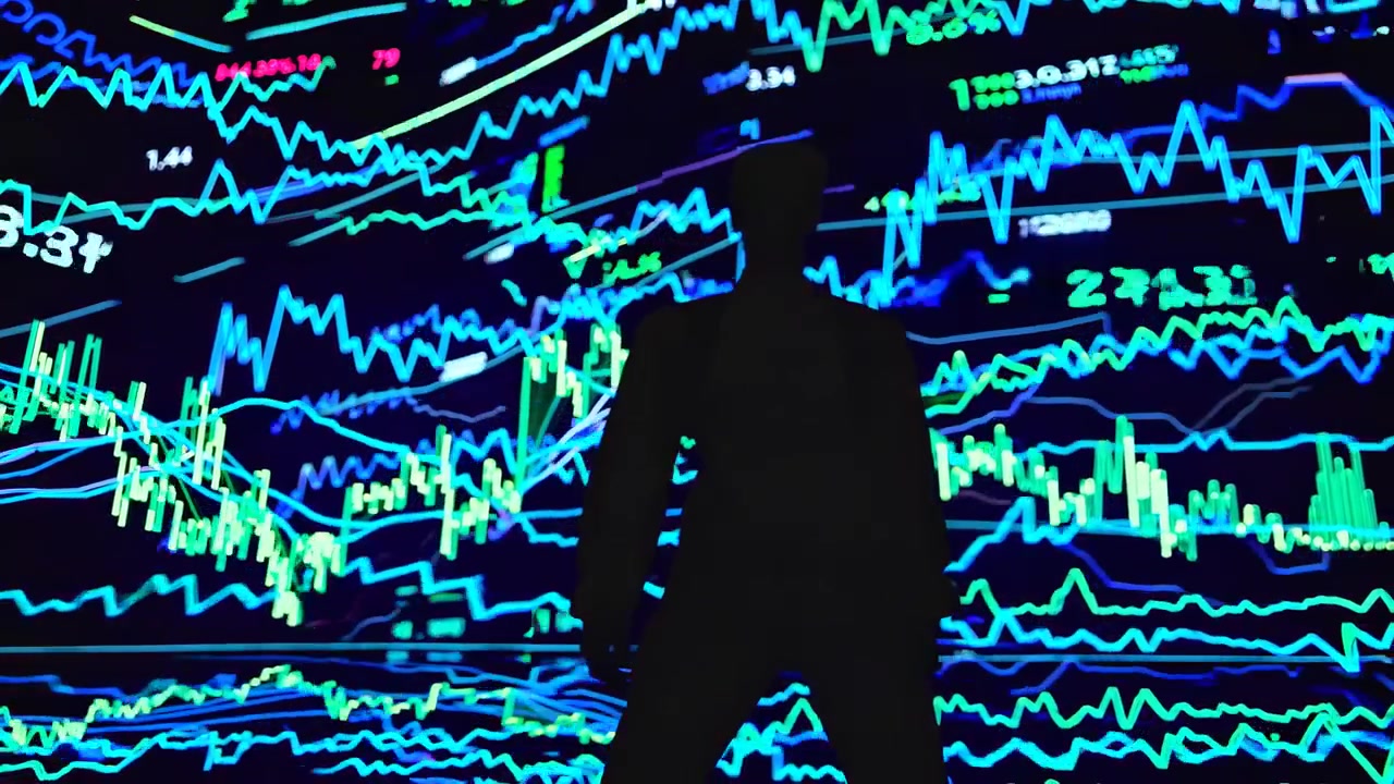 Silhouette of Man Analyzing Digital Stock Market Charts