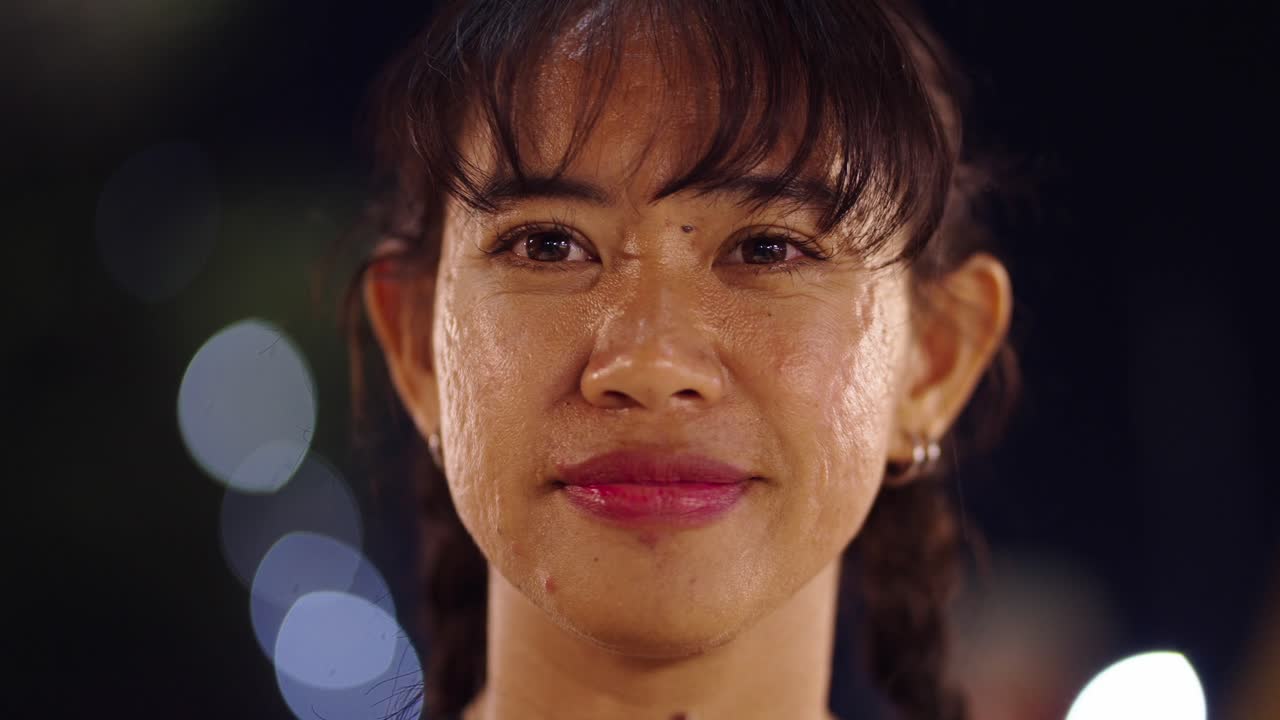 Close-up Portrait of an Emotional Woman with Sweat on Her Face at Night