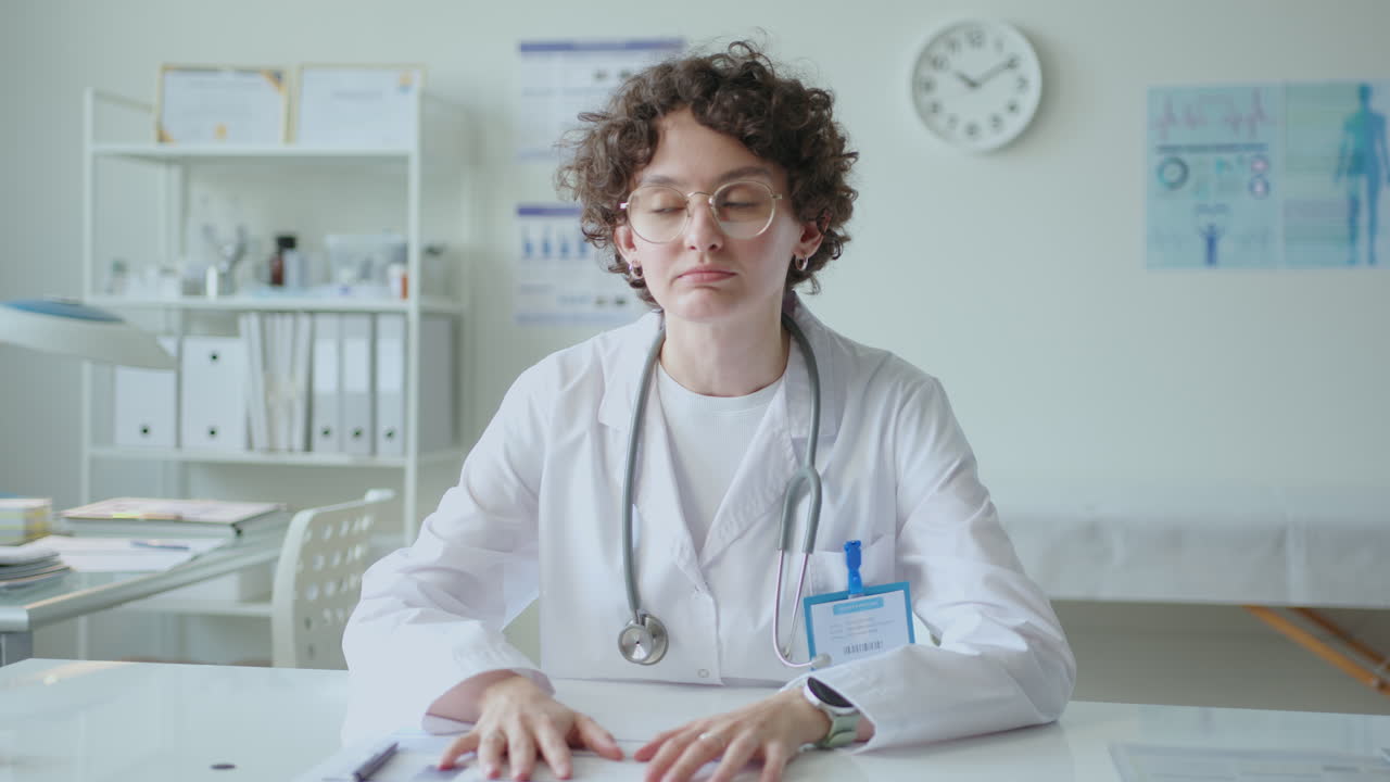 Young Female Doctor Speaking on Camera during Video Consultation