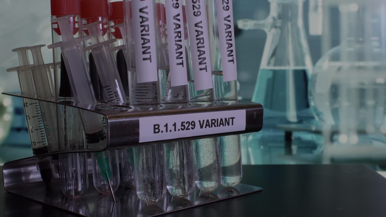 Close up shot of Omicron B.1.1.529 laboratory samples being placed into a rack, the new deadly variant of Covid 19 identified in South Africa