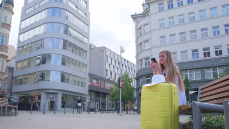 young woman with luggage at a tram stop. public transport