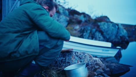 preparing freshly caught fish by the shore of reinsjøen in åfjord, trøndelag, norway - close up