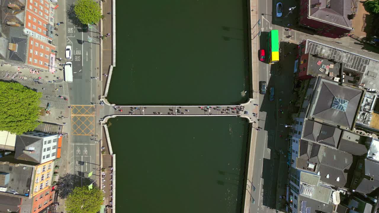 Overhead ascending aerial of the Ha'penny Bridge in Dublin City Centre, Ireland on a bright and sunny day. Filmed in 4K, 60FPS and with Rec709 color.