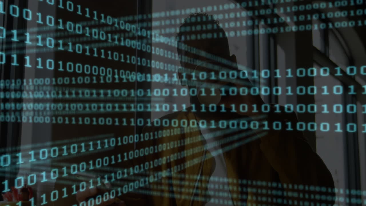 Binary code animation over silhouette of person in office setting