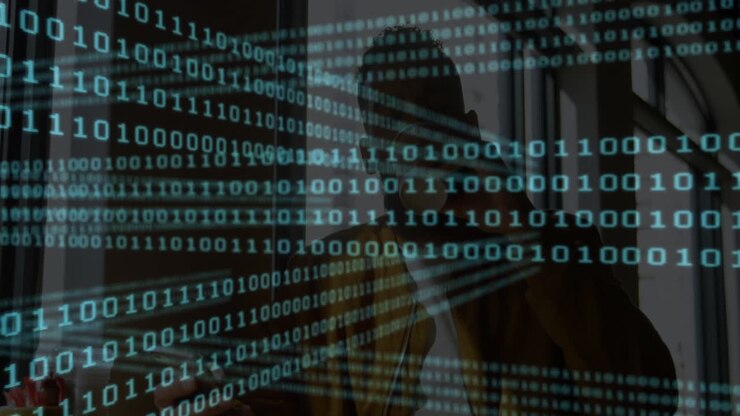Binary code animation over silhouette of person in office setting