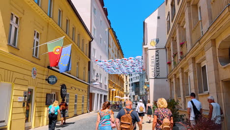 bratislava, slovakia, 2 june 2025: following a group of tourists walking by the cozy sunny paved street. walking by the historical part of bratislava, slovakia