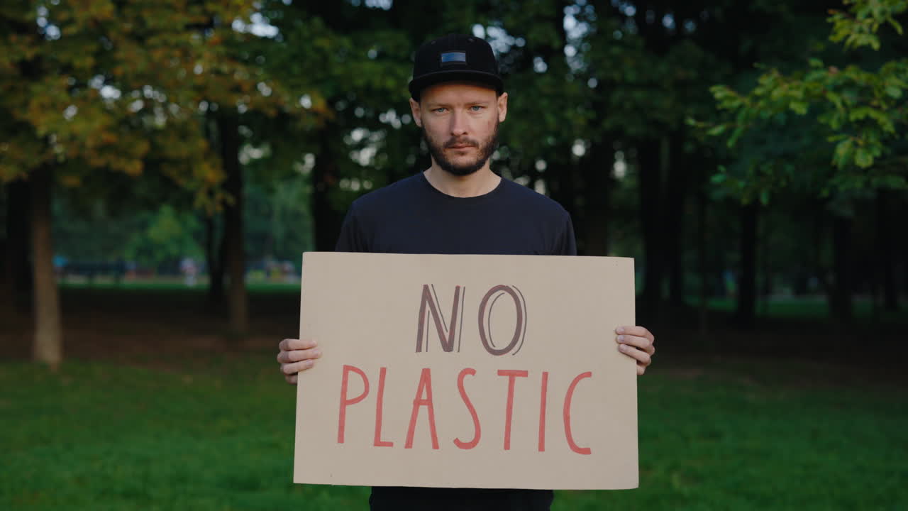 Man Protesting Against Plastic Pollution in Park