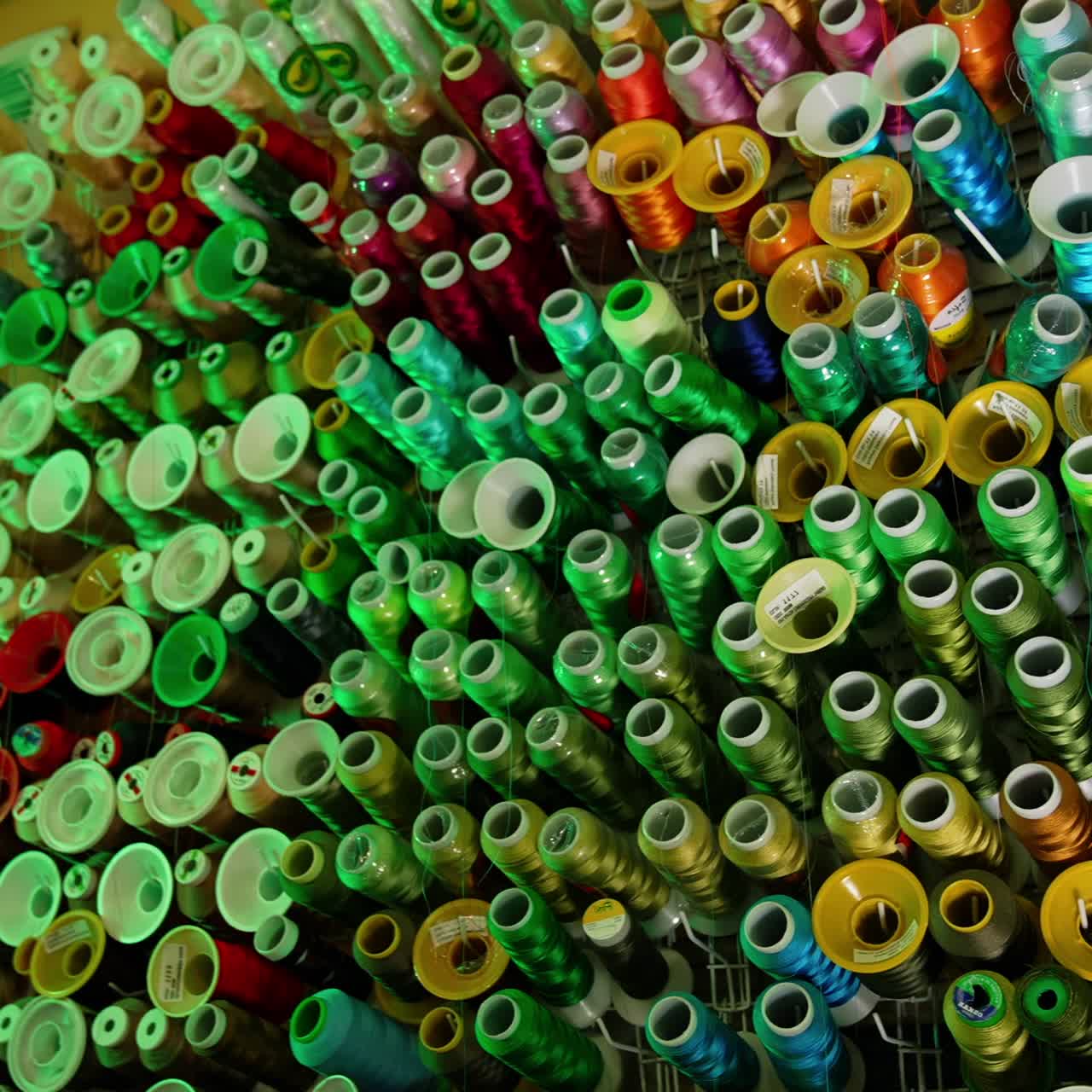 Colorful sewing threads background. Many spools of thread of different colors. Sewing tools. Hobbies and handicrafts