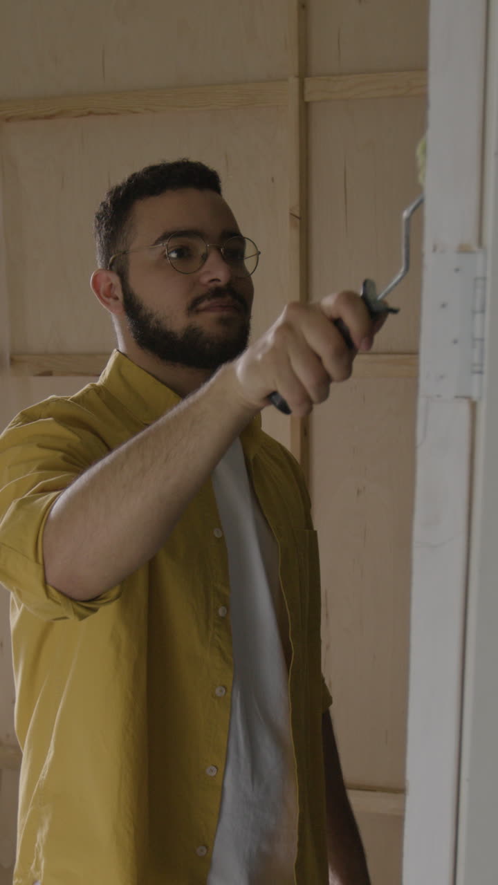 Man painting a door with a paint roller