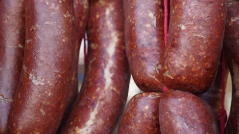 close up of turkish sucuk sausage hanging in a market