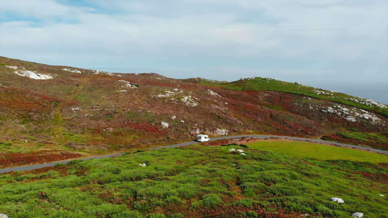RV on a Scenic Road Trip Through Hilly Landscape
