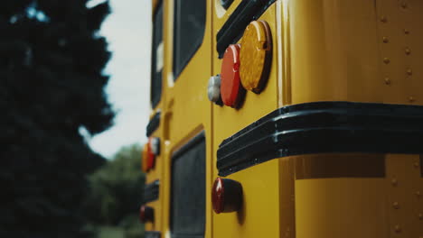 Rear-view-school-bus-yellow-red-headlights-close-up.-Stop-lights-on-schoolbus.