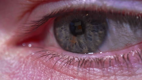 macro shot of a person's eye with reflection of mobile phone screen