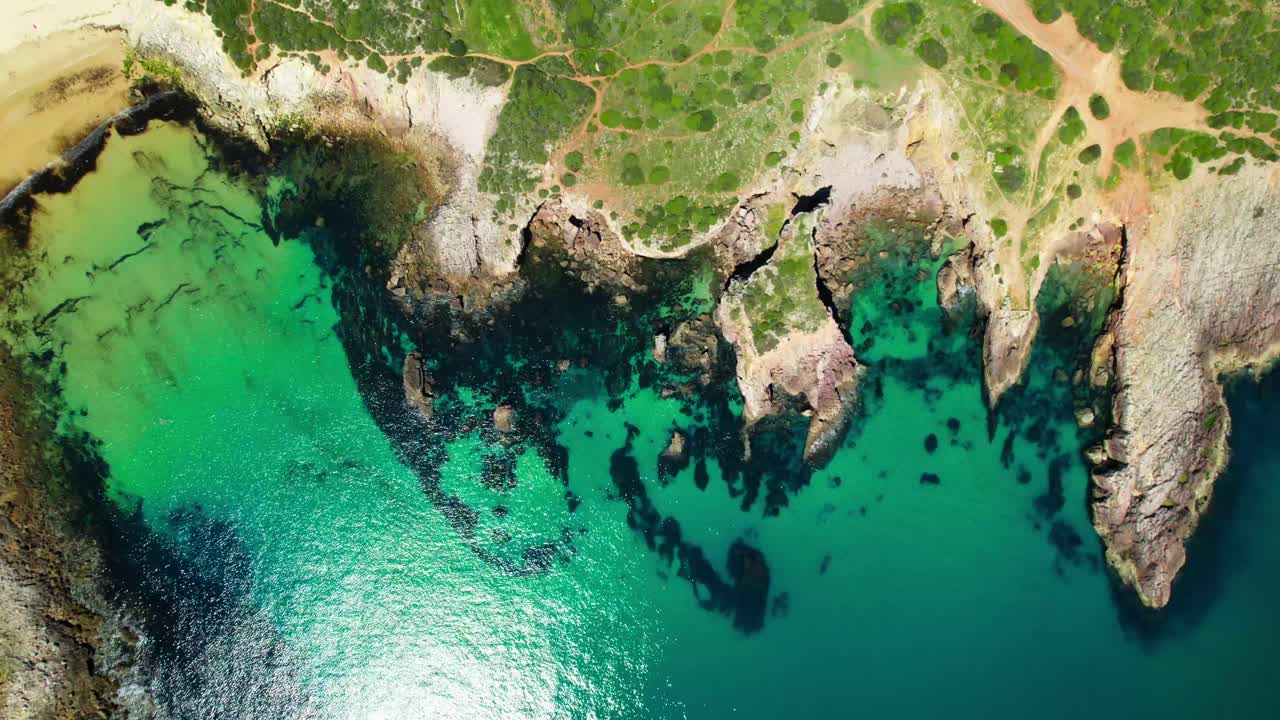 Rugged Cliffs By Calm And Clear Waters On A Sunny Summer Day. - aerial shot
