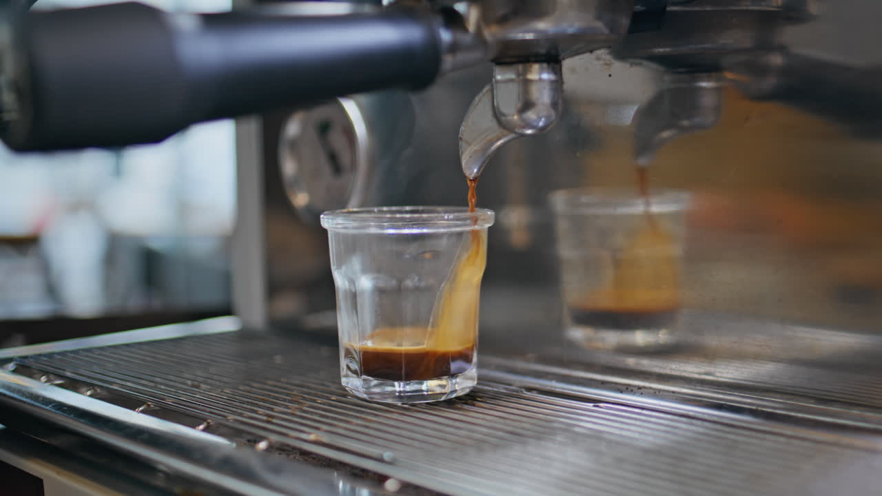 Bartender hands preparing o in cafeteria with espresso machine closeup