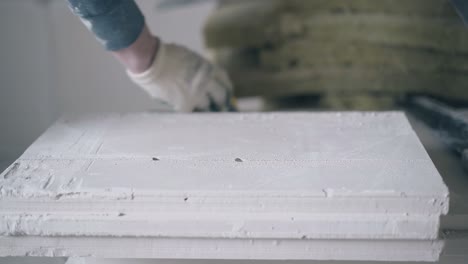 skilled man hands in gloves measure gypsum plasterboard