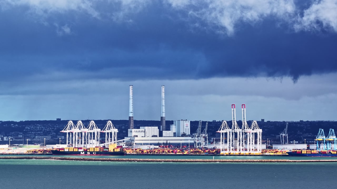 Timelapse of shipping port under dramatic stormy sky, industrial mood