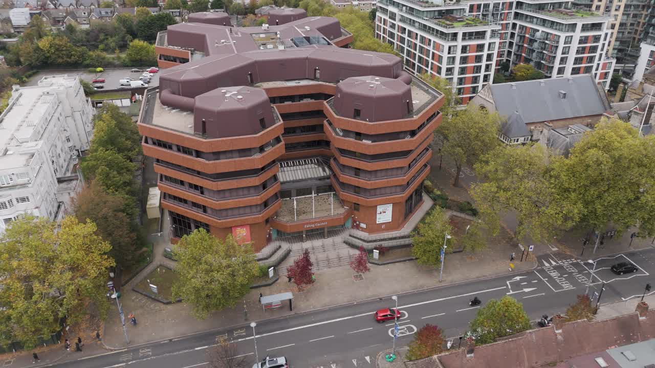 Aerial orbital view of Ealing Council headquarters, showcasing distinctive architecture and surrounding urban landscape, Ealing, London, UK, October 2024