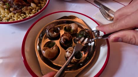 enjoying escargot at a parisian restaurant