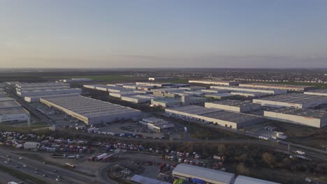 Aerial-shot-of-large-Warehouses-in-Bucharest-during-golden-sunset-in-Romania