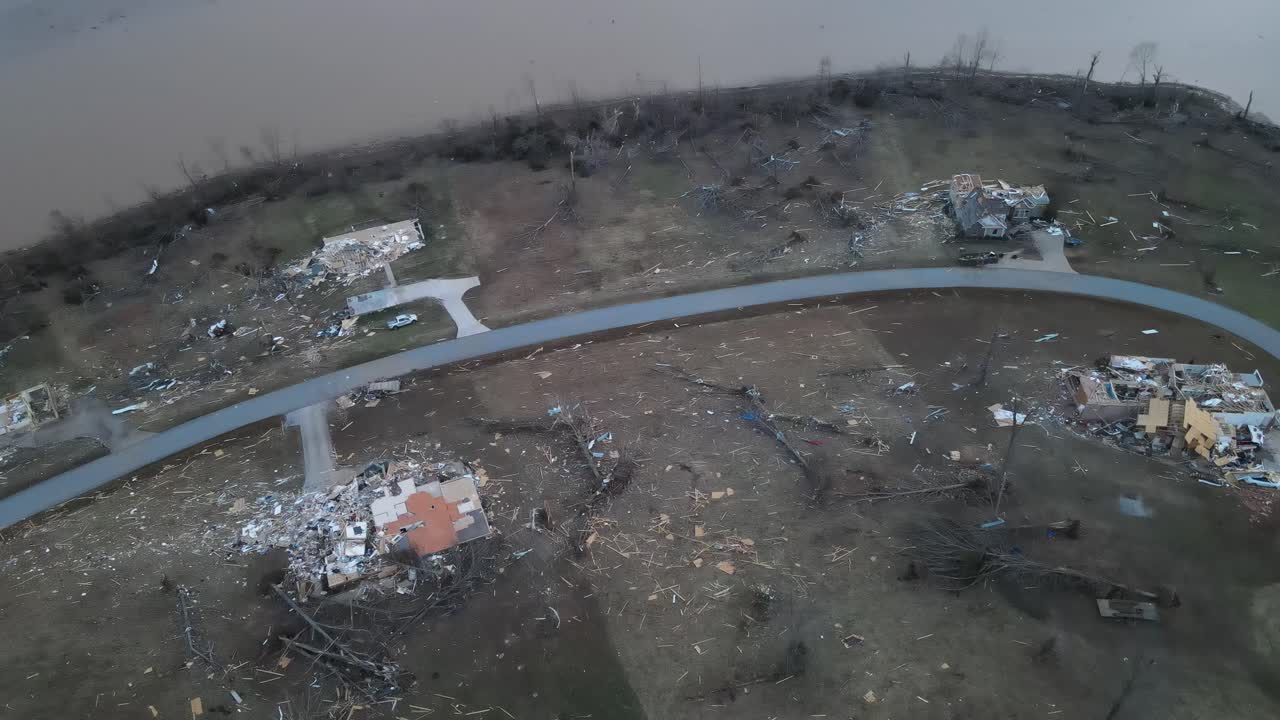 Aerial overview of a lakeside neighborhood destroyed by a tornado on Lake Barkley, Kentucky. 2021-12-10. Beautiful lake homes were destroyed by a very strong tornado. Dramatic debris trail visible