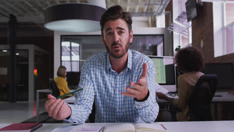 Happy-caucasian-businessman-having-video-call-sitting-in-front-of-computer