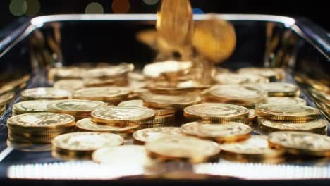 a captivating display of shimmering coins in a tray, showcasing their gleam and abundance against a softly lit background
