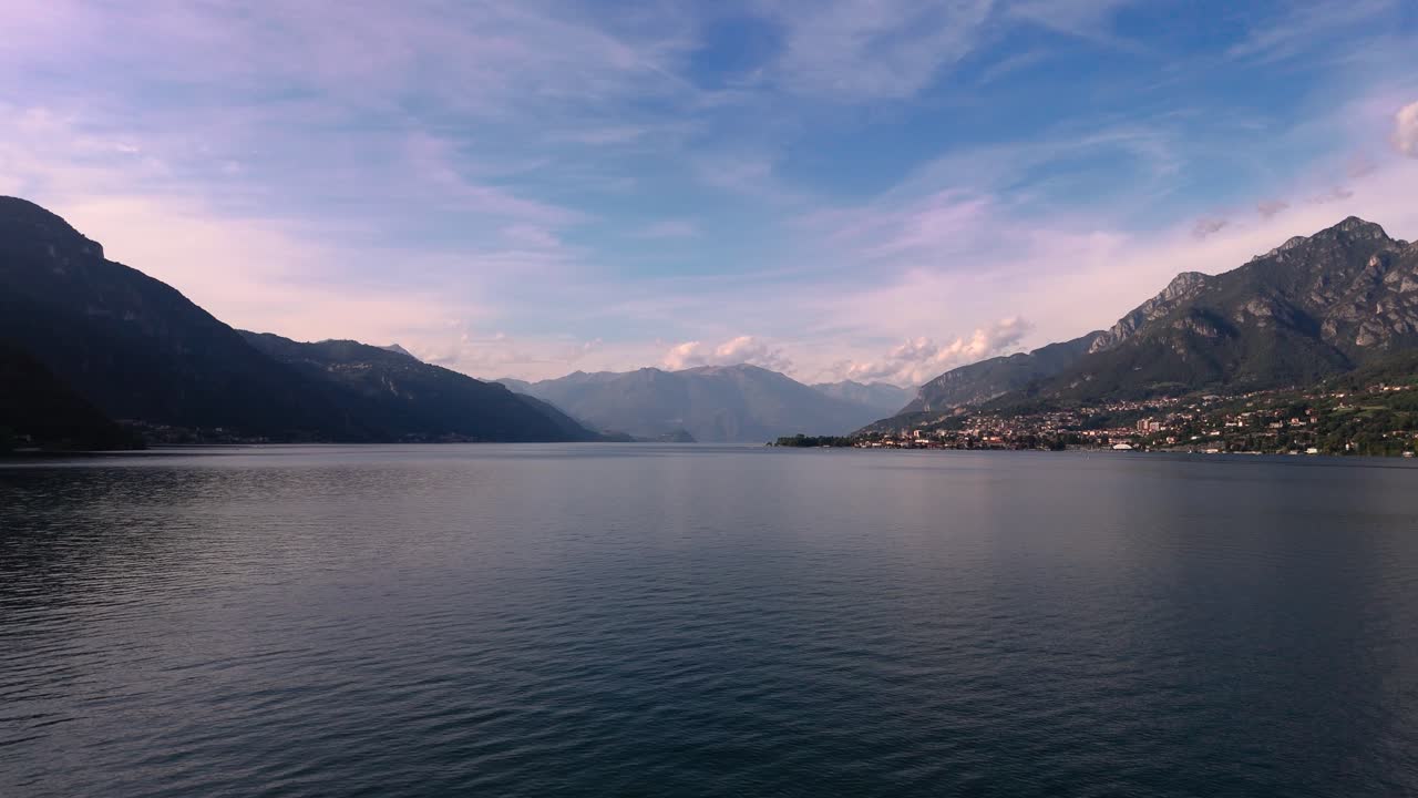 Fly over calm water at Lake Como in Italy