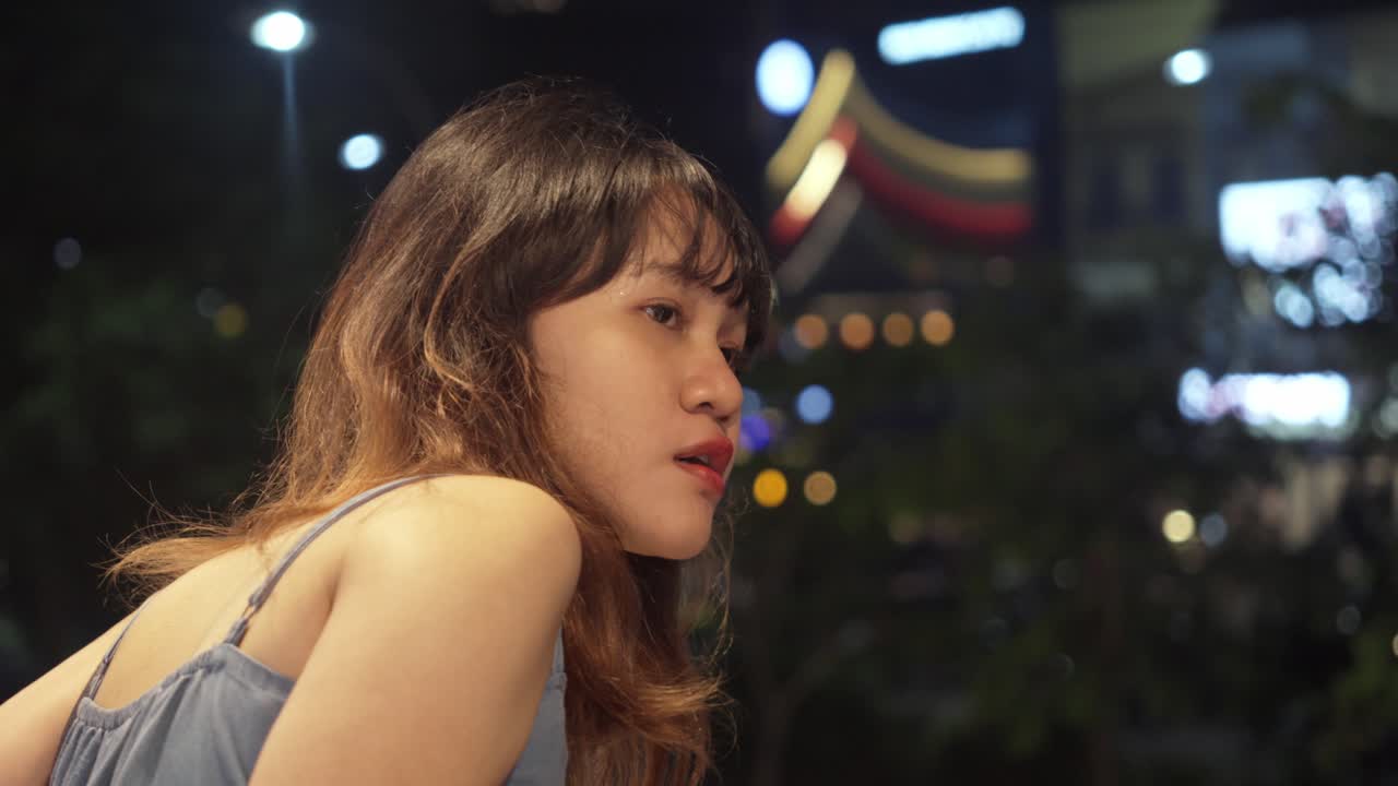 Young Asian Woman Looking For Something At The Balcony. Close-up Shot
