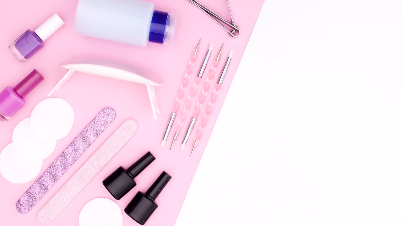 Manicure tools and nail polish bottles move on pink white theme. Stop motion