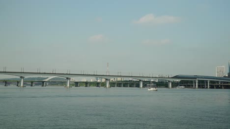 two unrecognizable people relaxing on bow of small yacht during luxury cruise tour on han river in yeouido marina