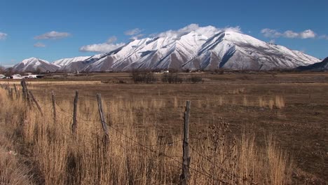 Long-shot-of-snow-capped-mountains-and-dry-brown-fields-in-Southern-Utah