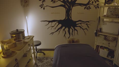 the massage room exudes a soothing atmosphere, complemented by a striking graffiti art piece adorning the wall.