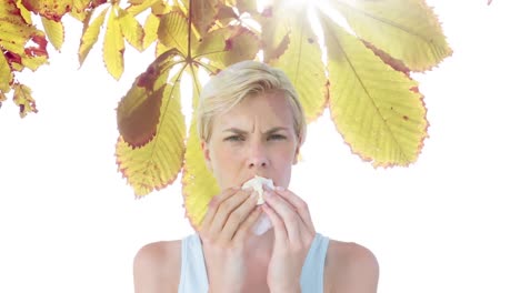 woman sneezing while suffering from allergy against autumn leaves 4k