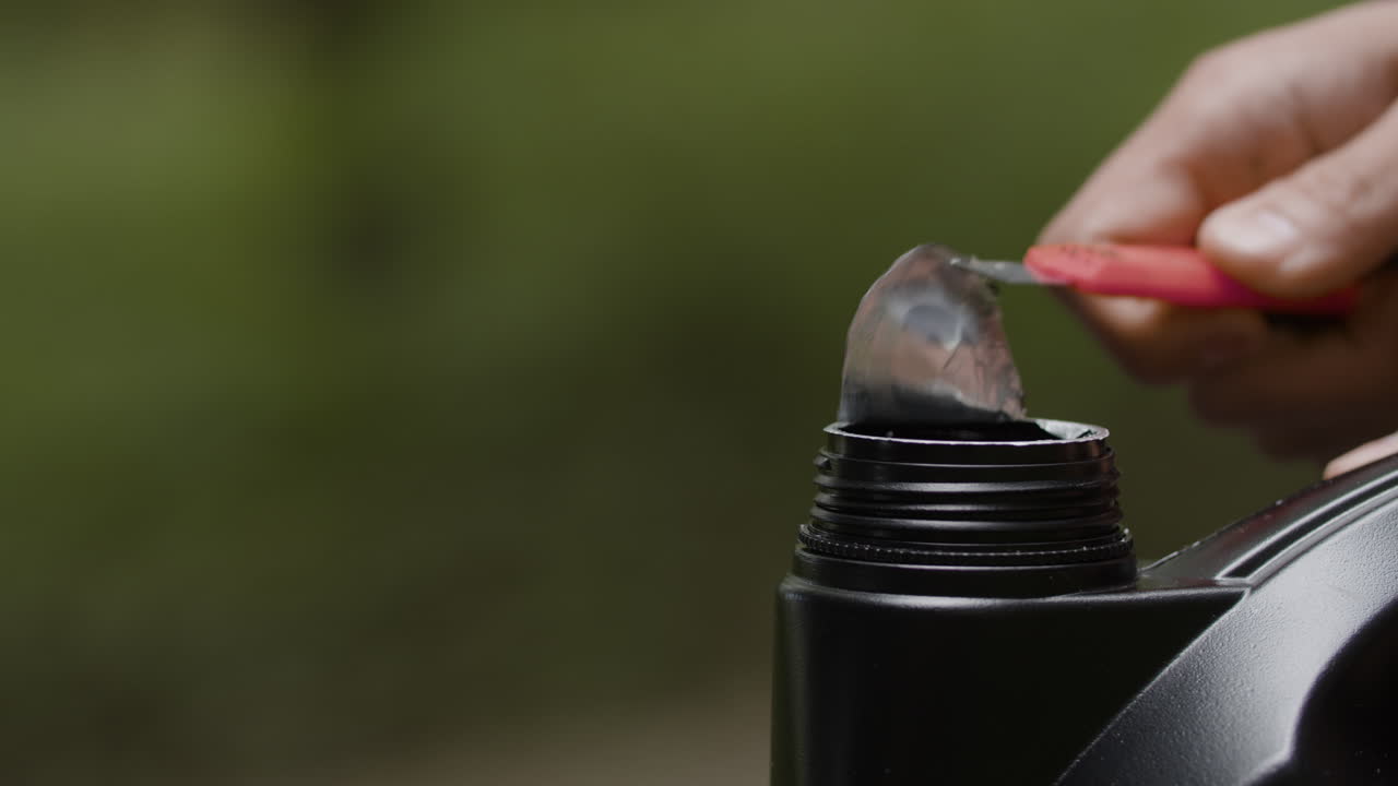 Opening an oil can with a utility knife
