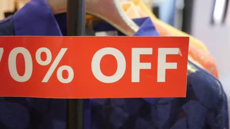 70% off sale sign on clothing rack