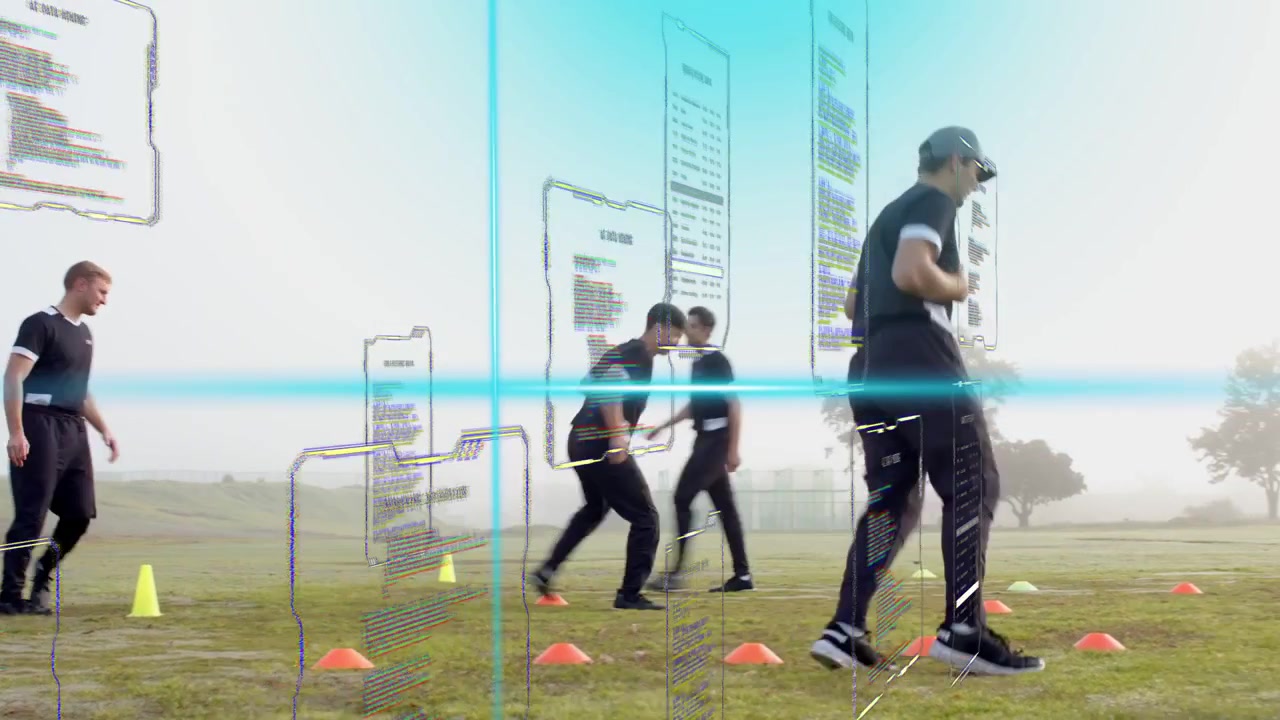 Seven men entering field and executing cone footwork drill for agility, UI shifting with camera