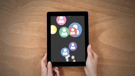 animation of media icons over hands with tablet