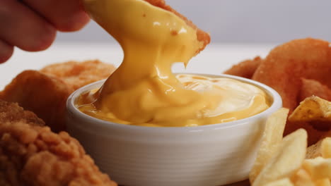 delicious fried food platter with cheese sauce