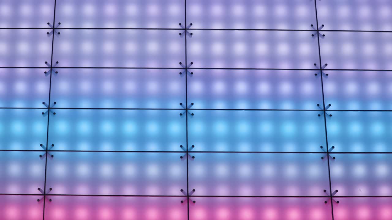 Zoomed in shot of color-changing LED lights on modern electronic billboard sign