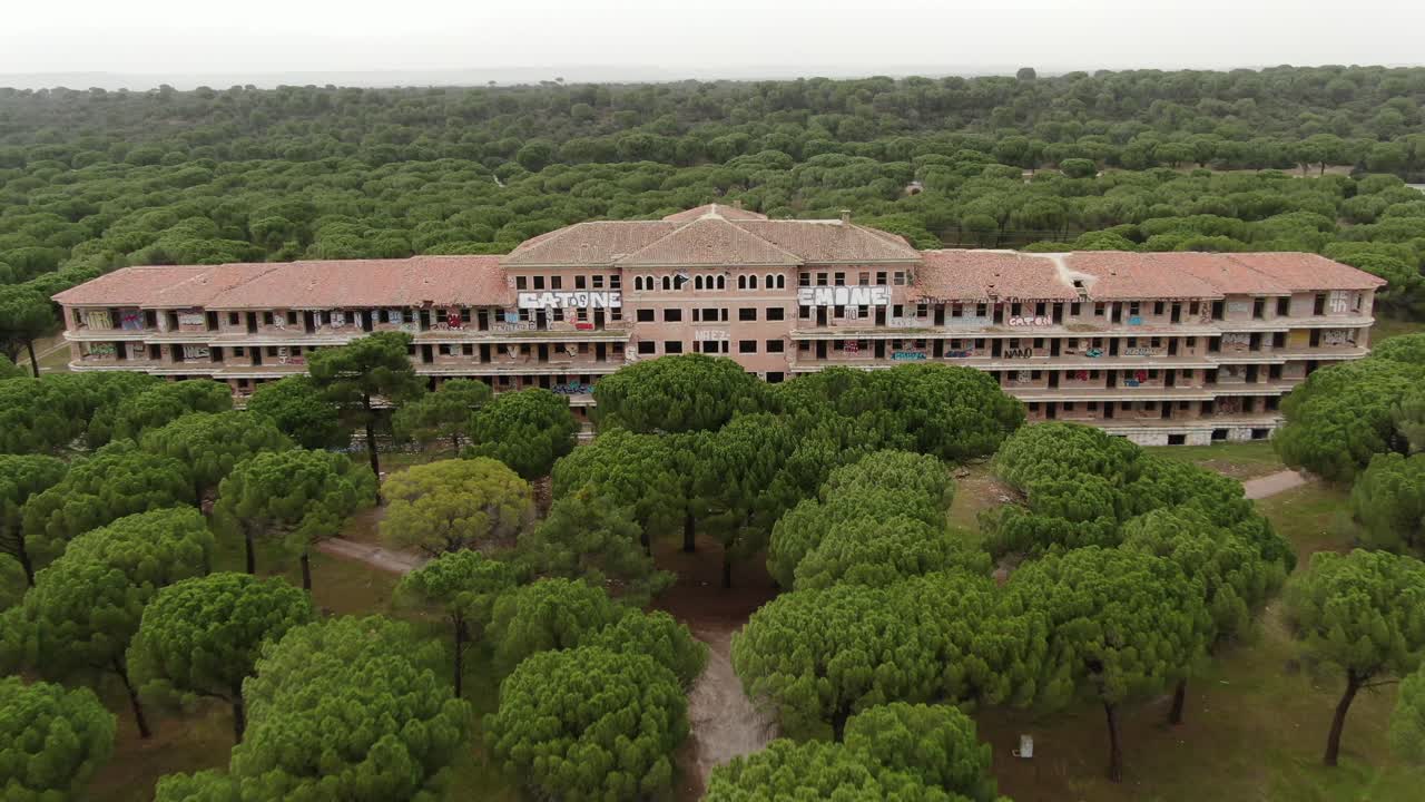 Large abandoned building in the midle of the pine forest (Viana de Cega Sanatorium, Valladolid) Aerial drone footage